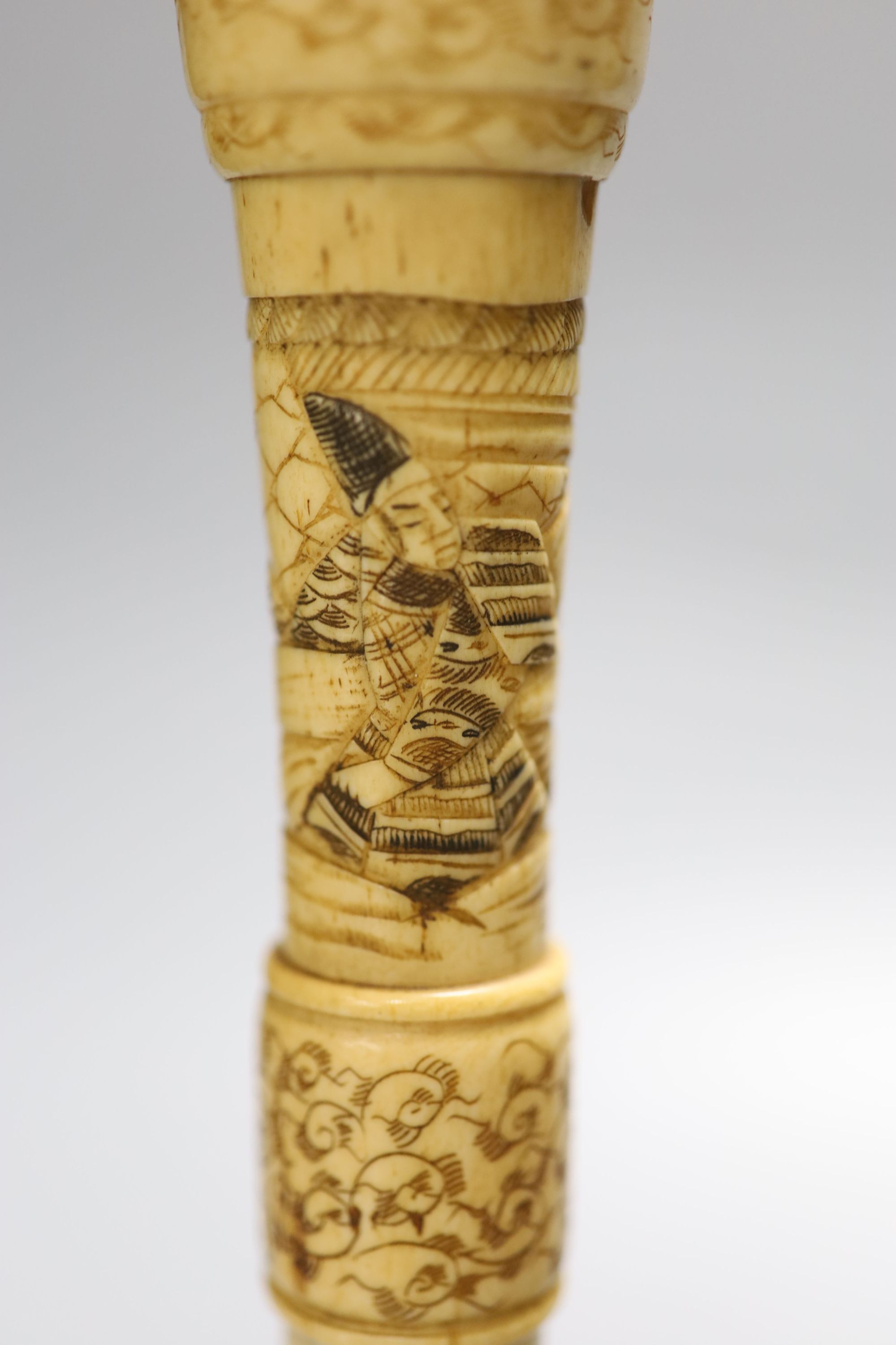 A pair of carved bone candlesticks, Meiji period, height 25cm